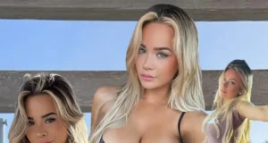 Emily Elizabeth posing indoors in a colorful micro bikini on a white couch.